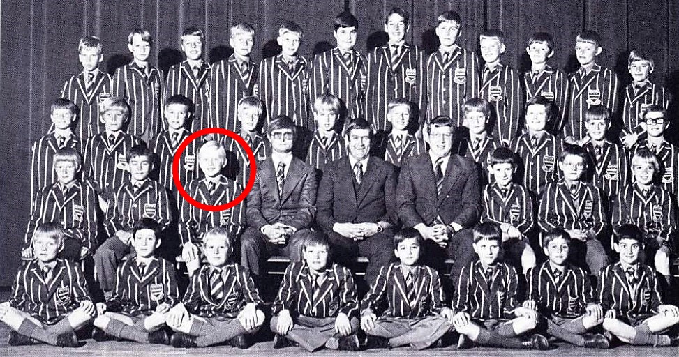 Black-and-white childhood school photograph with the young boy circled in red